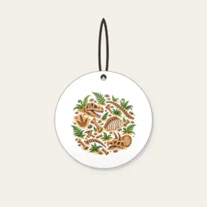 Dinosaur Bones and Fern Dig Scene Ceramic Ornament in white: Dinosaur bones and curling ferns lie scattered across warm sand in earthy brown and green.