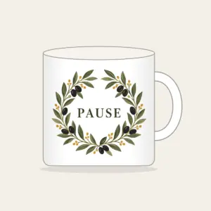 Olive Branch Wreath with PAUSE Mug in white: An olive branch wreath with dark fruits and ochre dots circles the word PAUSE in simple deep green serif letters.