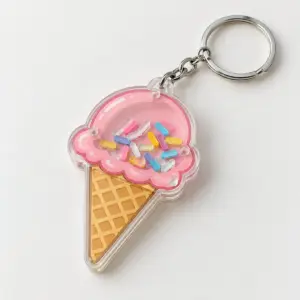 Ice Cream Cone Shaker Keychain with a cone with a pink scoop and cream waffle with a clear window of tiny sprinkles