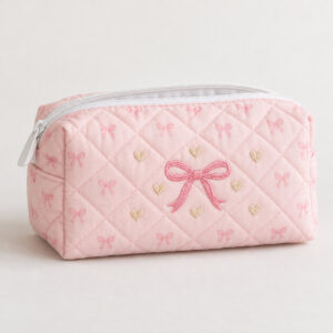 Pink Bow Quilted Makeup Pouch with embroidery of a pink satin-look bow with tiny hearts in pink, cream and gold on a quilted pouch, Pink Bow variant
