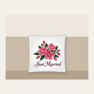 Cherry Blossoms and Just Married Wording Pillow in white: A cluster of cherry blossoms in deep rose pink and dark green, with the words “Just Married” in dark plum below.
