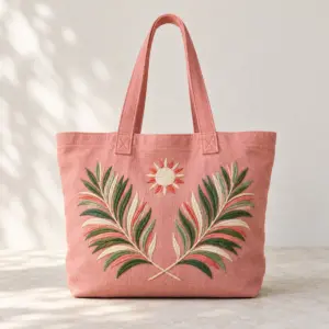 Pink Palm Embroidered Beach Tote with an embroidered palm frond pair and a small sun in white, coral and green cotton thread on the front