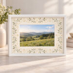 Heirloom Lace Museum Frame Box with lace-inspired mat pattern of small leaves and dots in ivory and soft gold around a central window showing an original sample photograph of a green hillside meadow, White 10in type