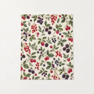 Wild Berry Fleece Blanket with a scatter of wild berries and leaves in plum, red and green on a cream ground