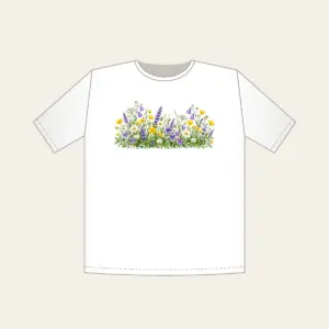 Wildflower Strip Beneath a Pale Sky T-Shirt in white: A strip of yellow, purple and white wildflowers runs along the lower edge beneath a pale sky gradient.