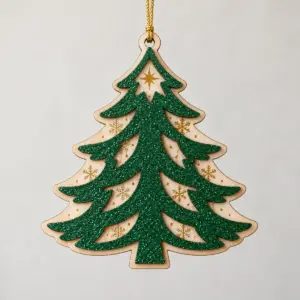 Glitter Pine Layered Wood Ornament with a Pine Green glitter top layer cut as a layered pine tree over a natural wood layer printed with gold snowflakes and a small star