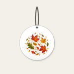 Drifting Autumn Leaves Ceramic Ornament in white: Autumn leaves drift in rust, gold and green.