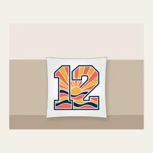 Sunrise Bands Number 12 Pillow in white: Sunrise bands in coral, gold and navy with the number “12” and no other text.
