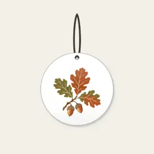 Oak Branch with Acorns Ceramic Ornament in white: An oak branch with three leaves and two acorns in rust, olive and cream.