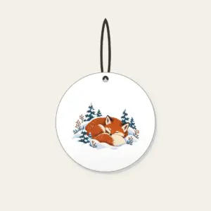 Sleeping Fox Among Snowy Pines Ceramic Ornament in white: A fox curled asleep in a snowbank with tiny pines, in rust, cream and slate blue.
