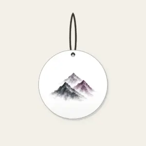 Three Overlapping Mountain Peaks Ceramic Ornament in white: Three overlapping mountain peaks in charcoal grey and muted plum, painted in a restrained brush style.