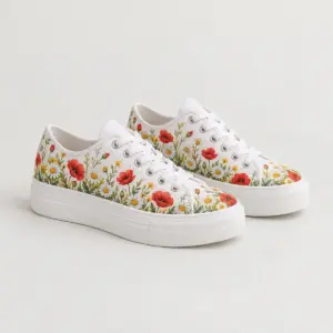 Painted Meadow Low Top Canvas Shoes with a painted-style meadow of daisies and poppies rising from the base of the canvas upper in red, yellow and green on white canvas, plain white sole