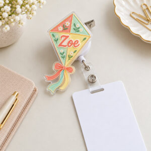 Kite-shaped two-layer acrylic badge reel in coral and mint with alligator clip