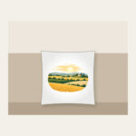 Farm Field Strips Under a Low Sun Pillow in white: Horizontal strips of gold, green and sand lie under a low pale sun.