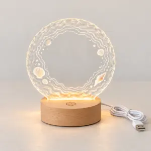 Tide Line Engraved Photo Night Light with fine white tide-line rings and shells printed on water-ripple acrylic around a clear center; small shell outline engraved on top of wood base