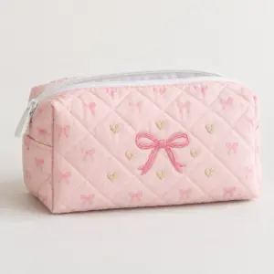 Pink Bow Quilted Makeup Pouch with embroidery of a pink satin-look bow with tiny hearts in pink, cream and gold on a quilted pouch, Pink Bow variant